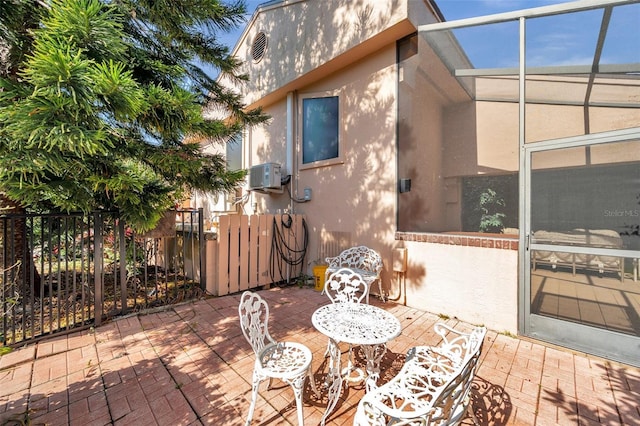 view of patio featuring a lanai and fence