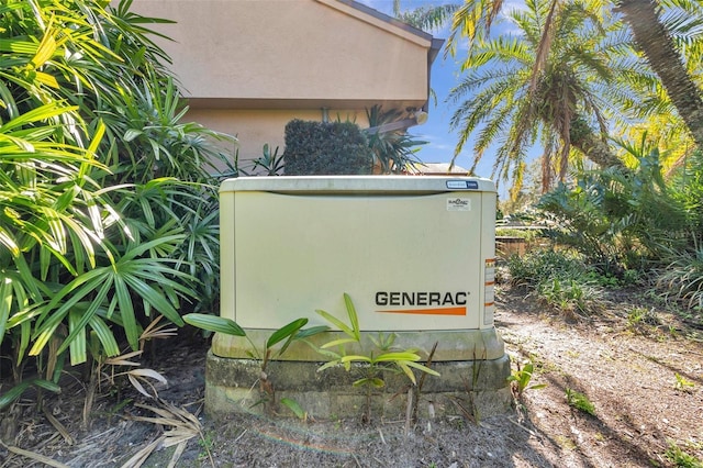 exterior details featuring a power unit and stucco siding