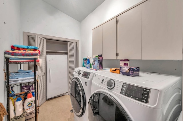 laundry area featuring light floors, cabinet space, and washer and dryer