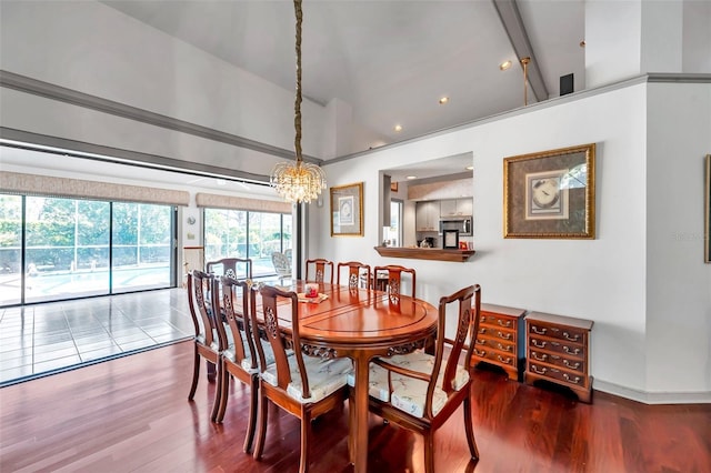 dining room with lofted ceiling, baseboards, and wood finished floors