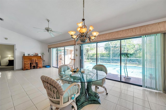 tiled dining area with visible vents, vaulted ceiling, a wealth of natural light, and ceiling fan with notable chandelier