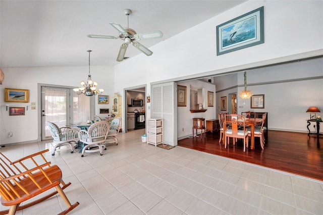 dining room with high vaulted ceiling, light tile patterned flooring, baseboards, and ceiling fan with notable chandelier