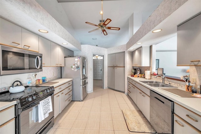 kitchen featuring tasteful backsplash, ceiling fan, stainless steel appliances, light countertops, and a sink