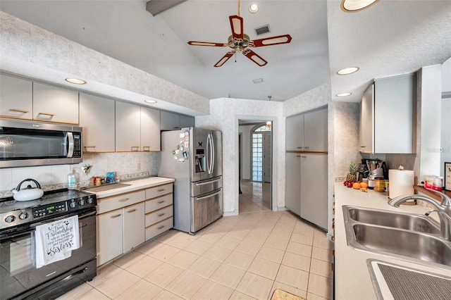 kitchen with appliances with stainless steel finishes, light countertops, a sink, and visible vents