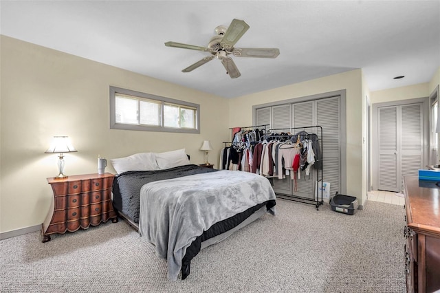 carpeted bedroom with a closet, ceiling fan, and baseboards