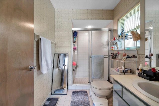 full bath featuring tile patterned flooring, a shower stall, toilet, and wallpapered walls