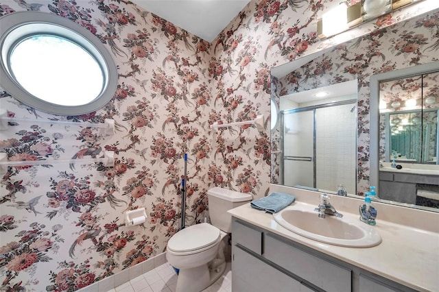 full bath featuring toilet, a stall shower, vanity, tile patterned flooring, and wallpapered walls