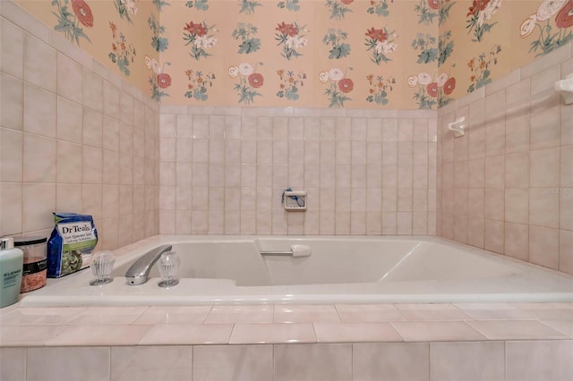 bathroom featuring a bath, tile walls, and wallpapered walls