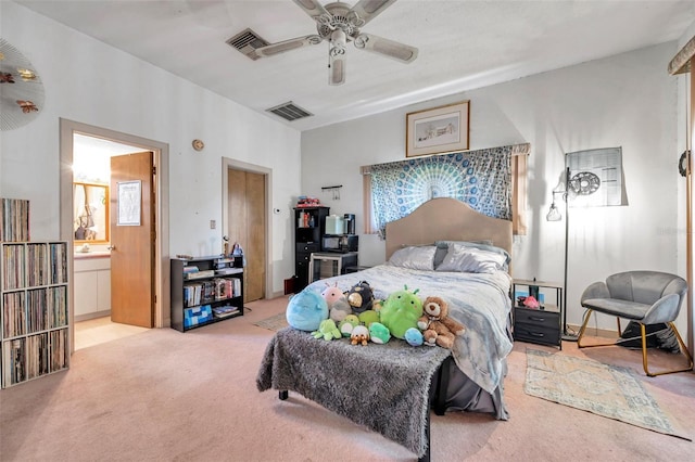 bedroom with light carpet, ceiling fan, visible vents, and connected bathroom