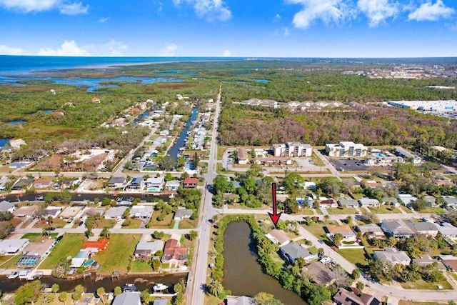 birds eye view of property with a water view and a residential view