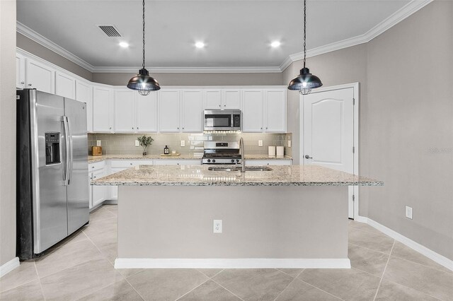 17541 Corkwood Bend Trl, Punta Gorda, FL 33982 - kitchen with appliances with stainless steel finishes, a sink, decorative backsplash, crown molding, and a center island with sink