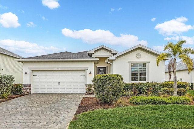 17541 Corkwood Bend Trl, Punta Gorda, FL 33982 - single story home featuring stucco siding, decorative driveway, and a garage