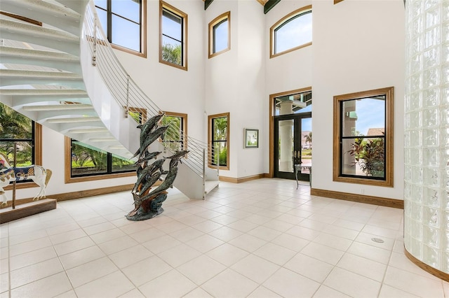 foyer featuring light tile patterned floors and baseboards