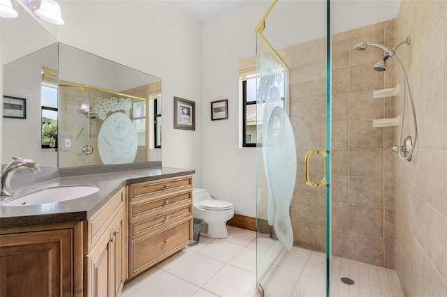 full bath with plenty of natural light, vanity, a shower stall, and tile patterned floors