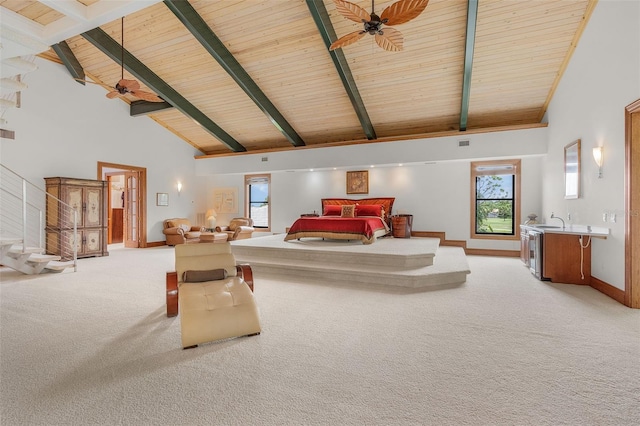 interior space with high vaulted ceiling, light colored carpet, a sink, baseboards, and beamed ceiling