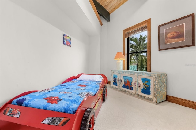 bedroom with carpet floors, beamed ceiling, and baseboards