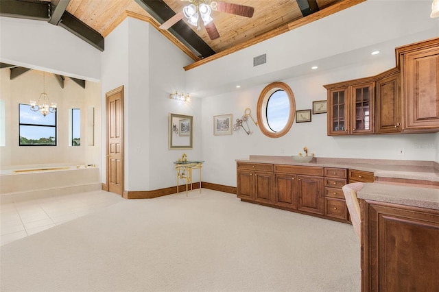 bathroom featuring wood ceiling, visible vents, a garden tub, and beamed ceiling