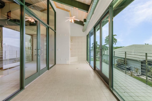 interior space with ceiling fan, french doors, and lofted ceiling