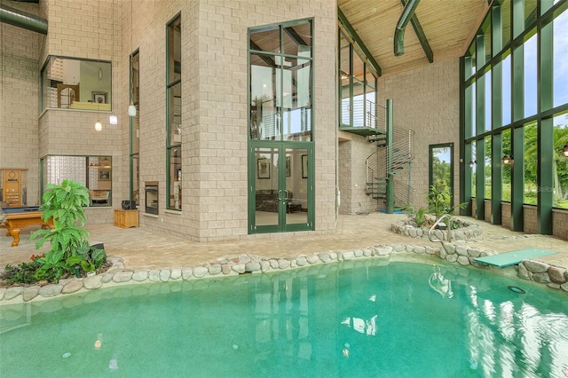 view of pool featuring a ceiling fan and french doors