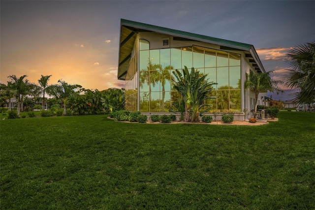 view of side of property with a lawn