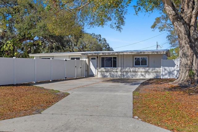 ranch-style house featuring fence