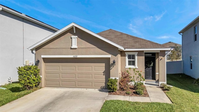 ranch-style home featuring roof with shingles, stucco siding, an attached garage, driveway, and a front lawn