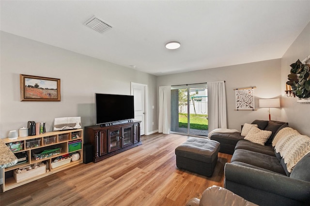 living room with visible vents and wood finished floors