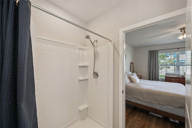 ensuite bathroom featuring a ceiling fan, a shower with curtain, ensuite bath, and wood finished floors