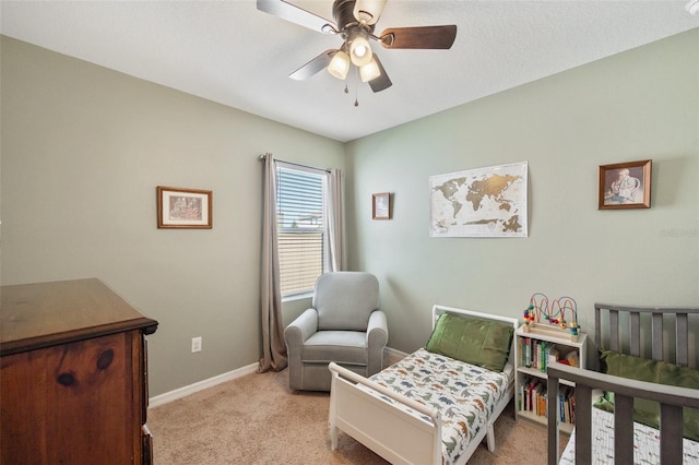 carpeted bedroom featuring ceiling fan and baseboards