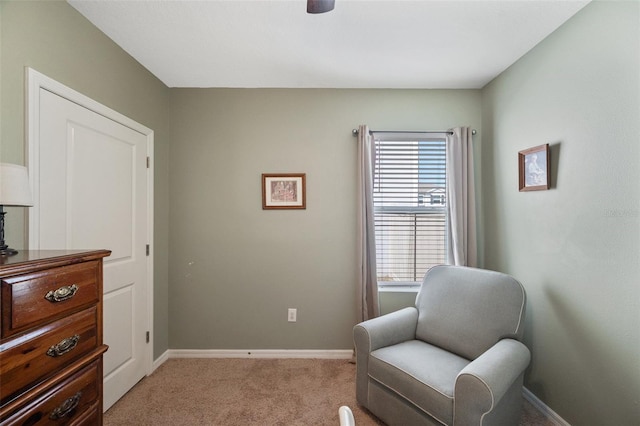 living area with light carpet and baseboards