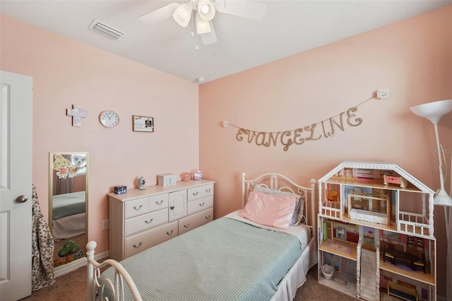 carpeted bedroom featuring a ceiling fan, visible vents, and baseboards