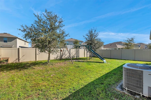 view of yard with a fenced backyard, a playground, a residential view, and cooling unit