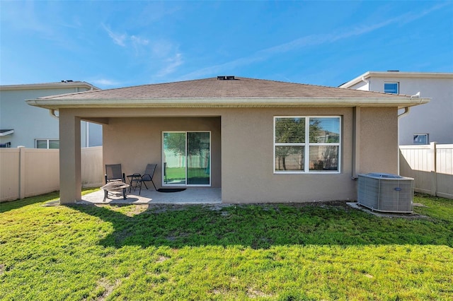 rear view of house with a patio, fence, a lawn, and stucco siding