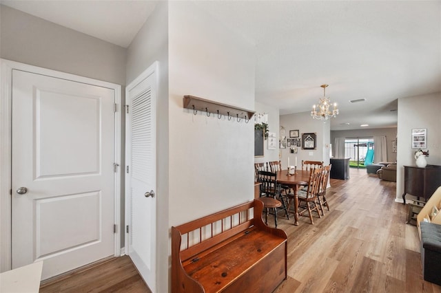 interior space featuring a chandelier and wood finished floors