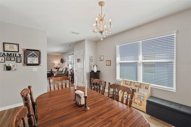 dining area with a chandelier, visible vents, and plenty of natural light