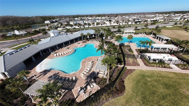 community pool featuring a residential view and a patio