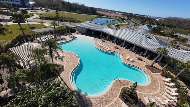 community pool with a water view and a patio