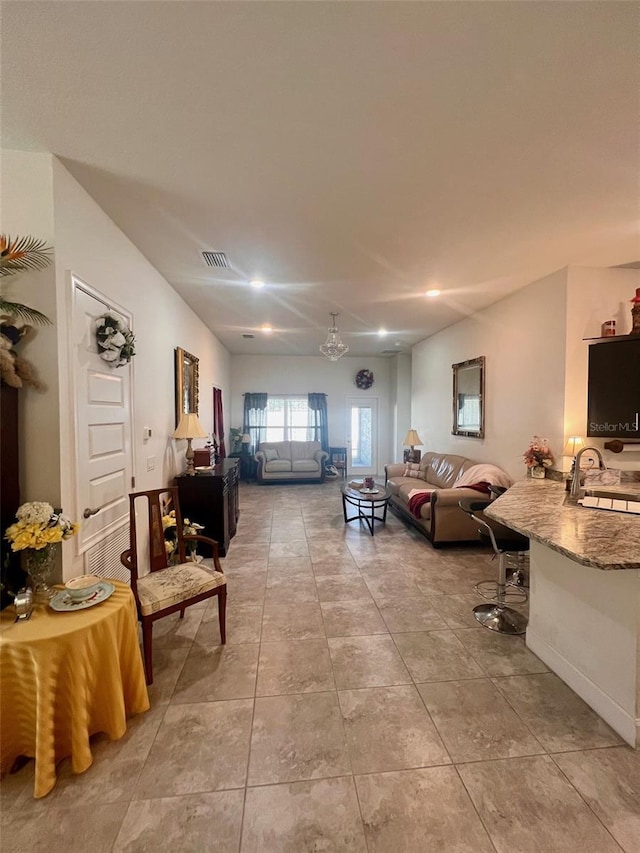 living area with an inviting chandelier, recessed lighting, visible vents, and light tile patterned flooring