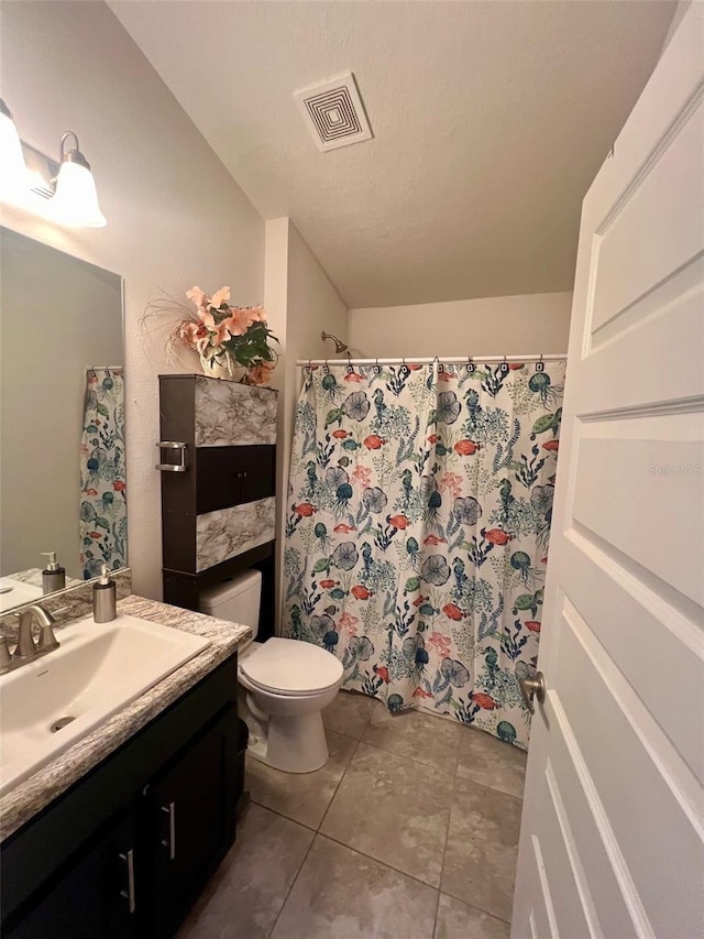 bathroom featuring visible vents, a shower with shower curtain, toilet, vanity, and tile patterned flooring