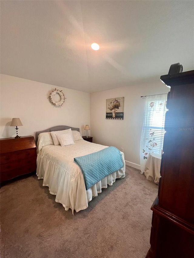 bedroom with carpet flooring and baseboards