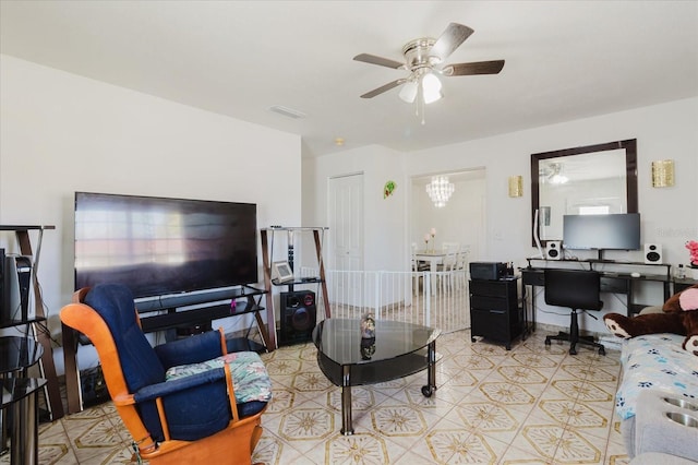 living area with ceiling fan with notable chandelier and visible vents