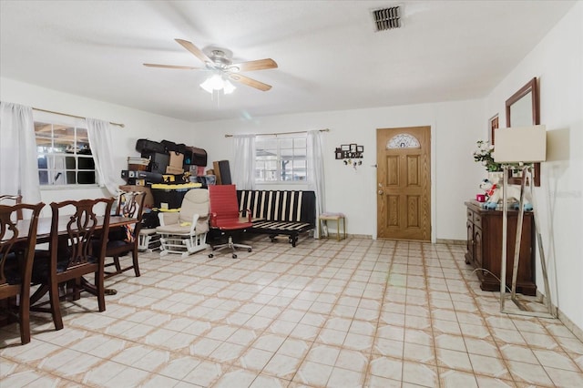 interior space with ceiling fan and visible vents