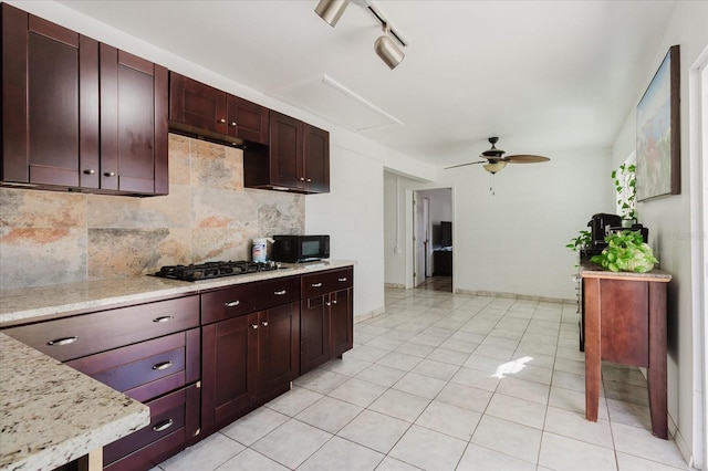 kitchen featuring baseboards, a ceiling fan, black appliances, backsplash, and light tile patterned flooring