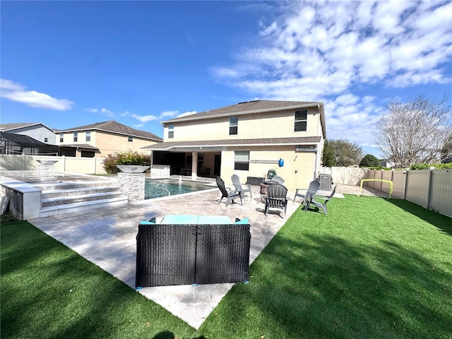 rear view of house featuring a fenced in pool, a patio, stucco siding, a lawn, and a fenced backyard