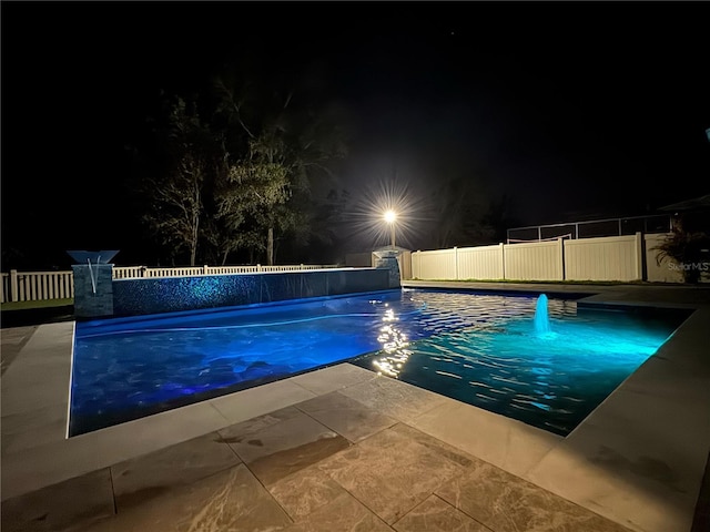 pool at twilight featuring a fenced backyard and a fenced in pool