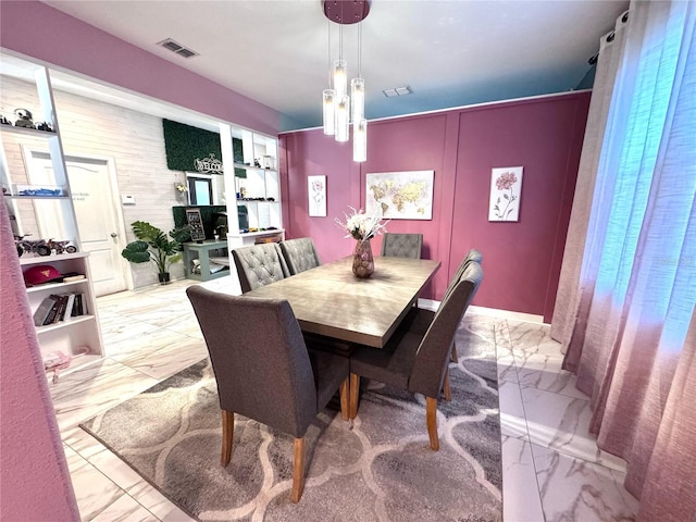 dining room featuring marble finish floor and visible vents