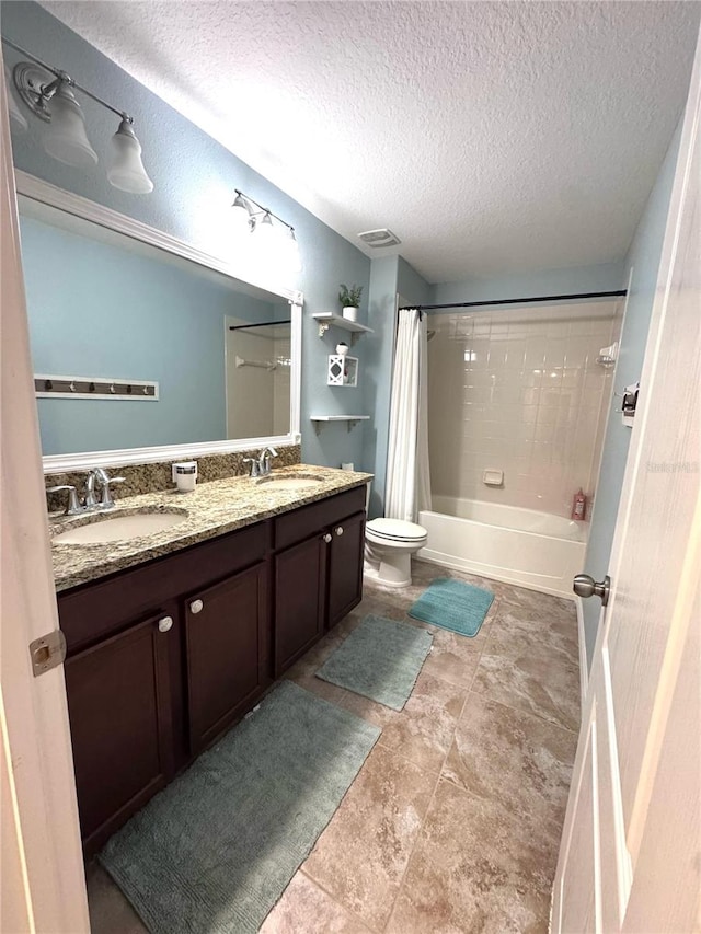 bathroom featuring double vanity, shower / tub combo, visible vents, toilet, and a sink