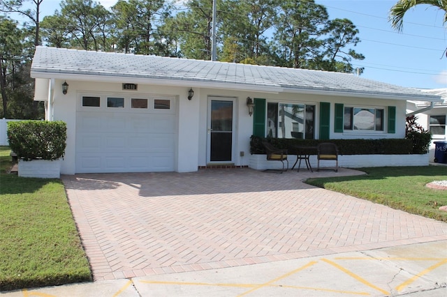 single story home featuring an attached garage, a tiled roof, a front lawn, and stucco siding