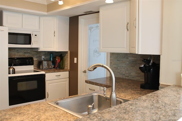 kitchen with decorative backsplash, electric range oven, white microwave, white cabinetry, and a sink