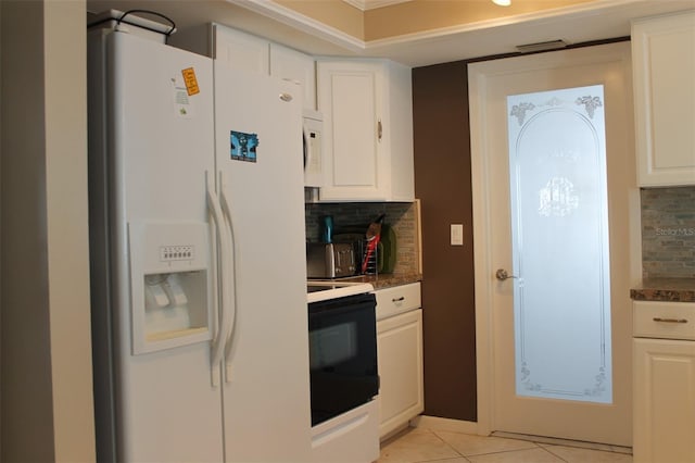 kitchen with white appliances, light tile patterned floors, and white cabinetry